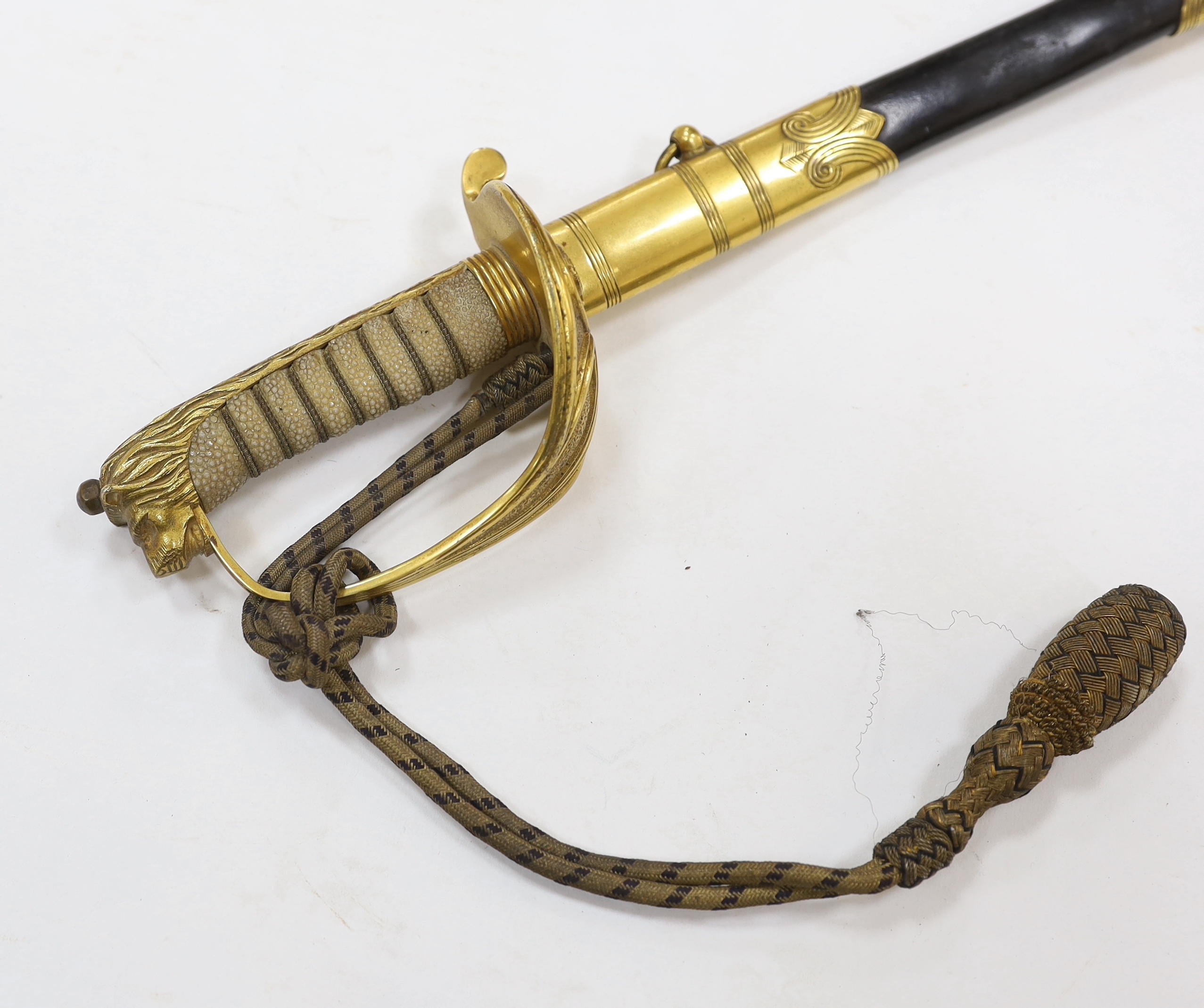 A World War I naval sword with folding guard engraved J.W. Collett R.N., regulation gilt hilt and scabbard mounts, the blade has been refinished and furniture regilded, with bullion dress knot, blade 78.5cm